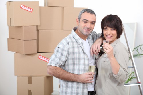 Professional movers handling office equipment